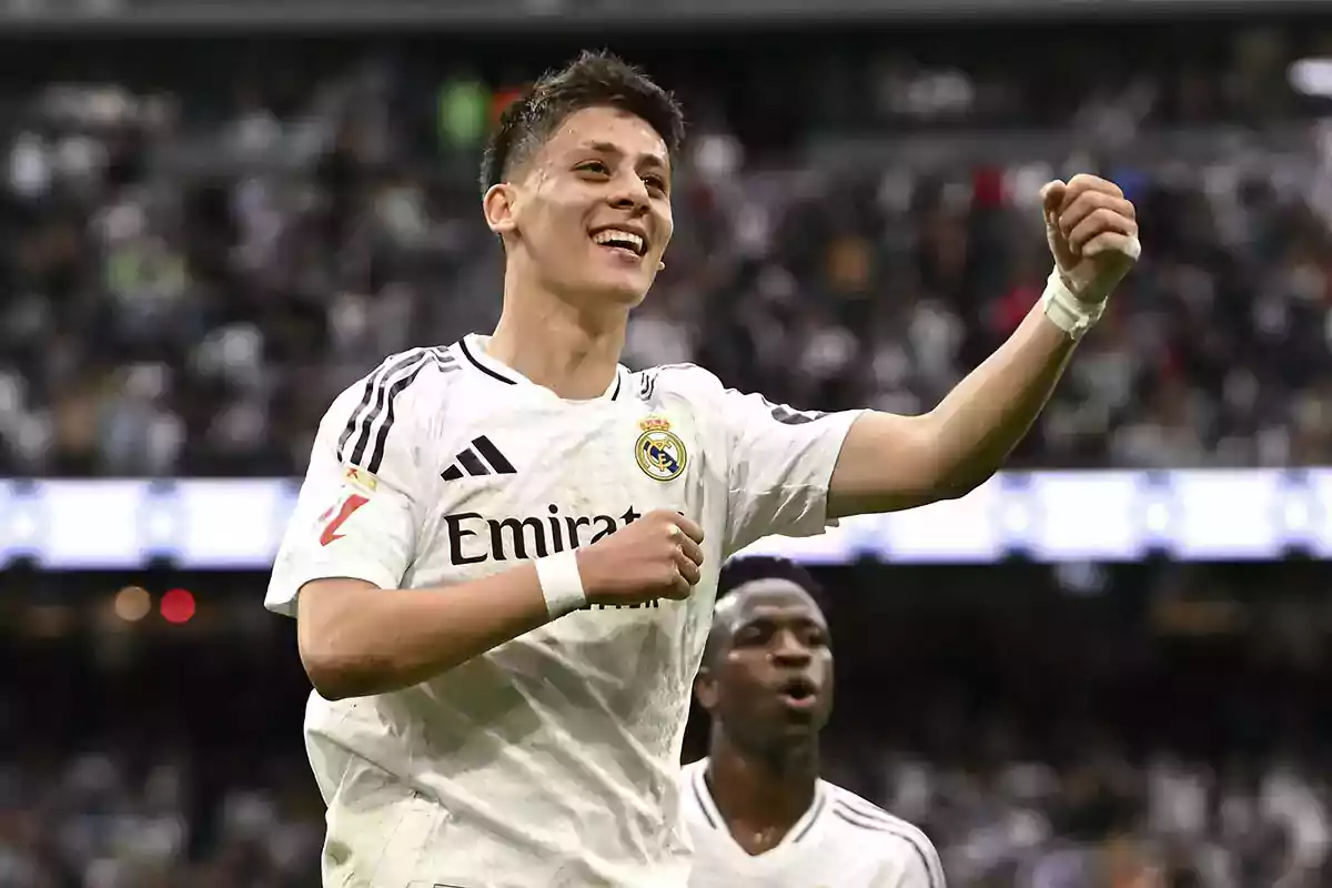 Real Madrid player celebrating a goal in the stadium with a big smile and fist raised Real Madrid player celebrating a goal in the stadium with a big smile and fist raised