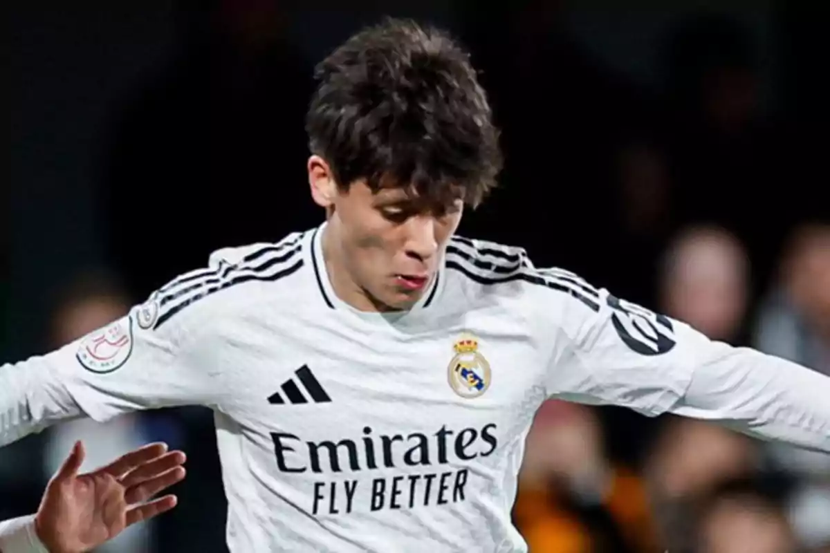 A soccer player in the white uniform of Real Madrid in action during a match. A soccer player in the white uniform of Real Madrid in action during a match.