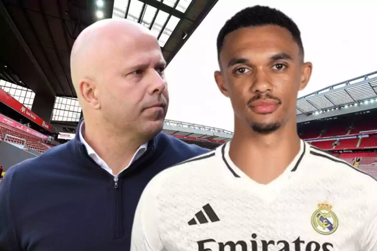 Two men in a soccer stadium, one wearing a white t-jersey and the other wearing a dark sweater.