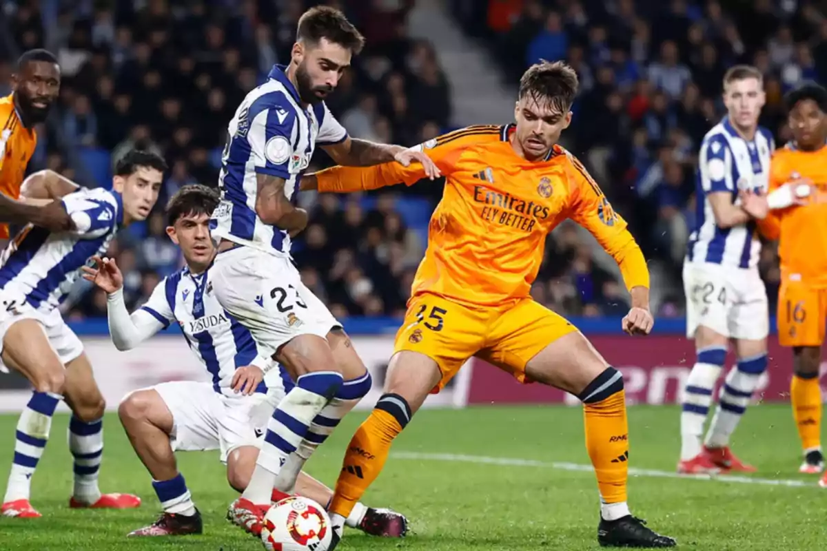 Soccer players from two teams compete for the ball in a match.