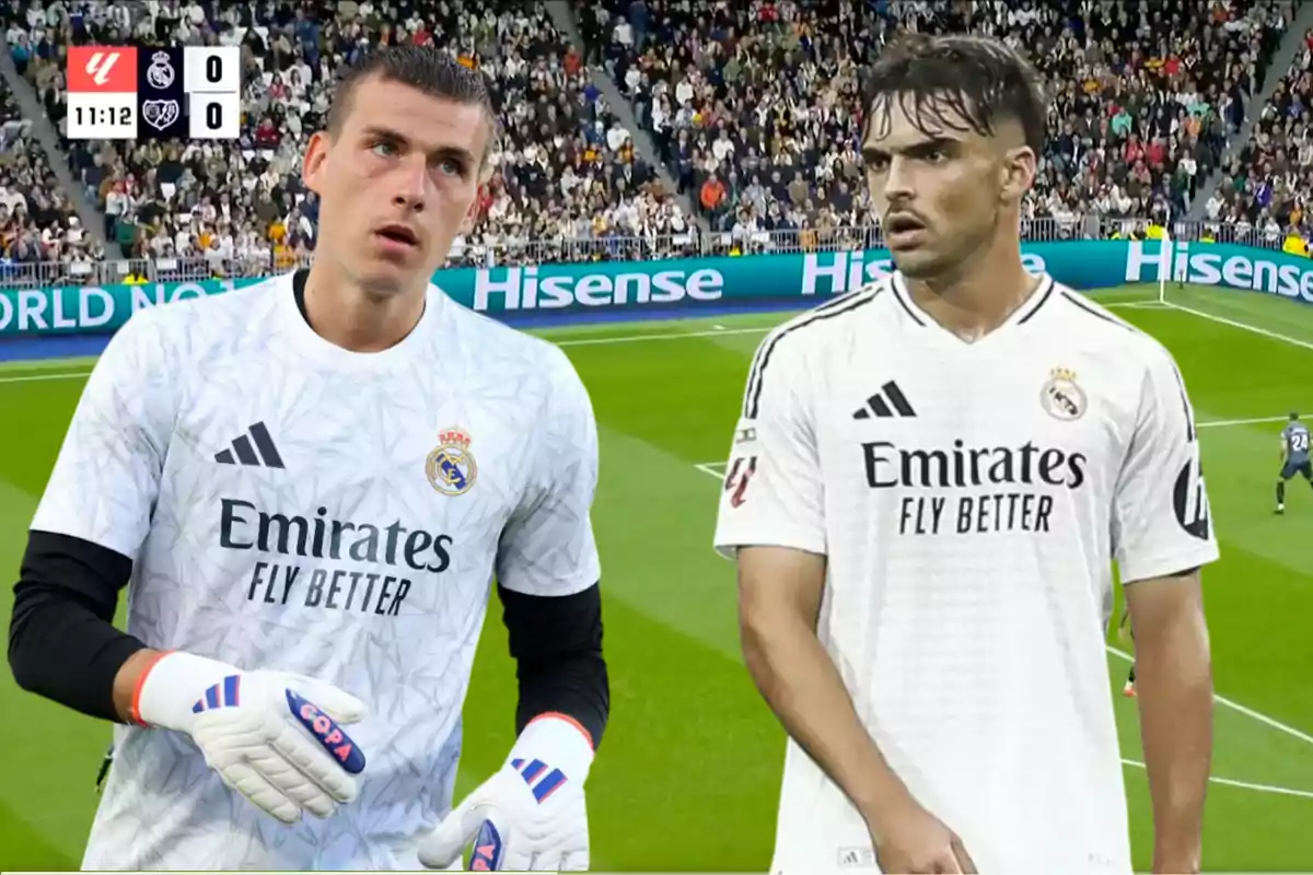 Two Real Madrid players on the field during a match, with the scoreboard showing a zero-zero tie.