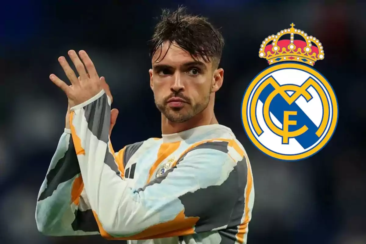 A player in training uniform applauds, with the Real Madrid crest in the background.