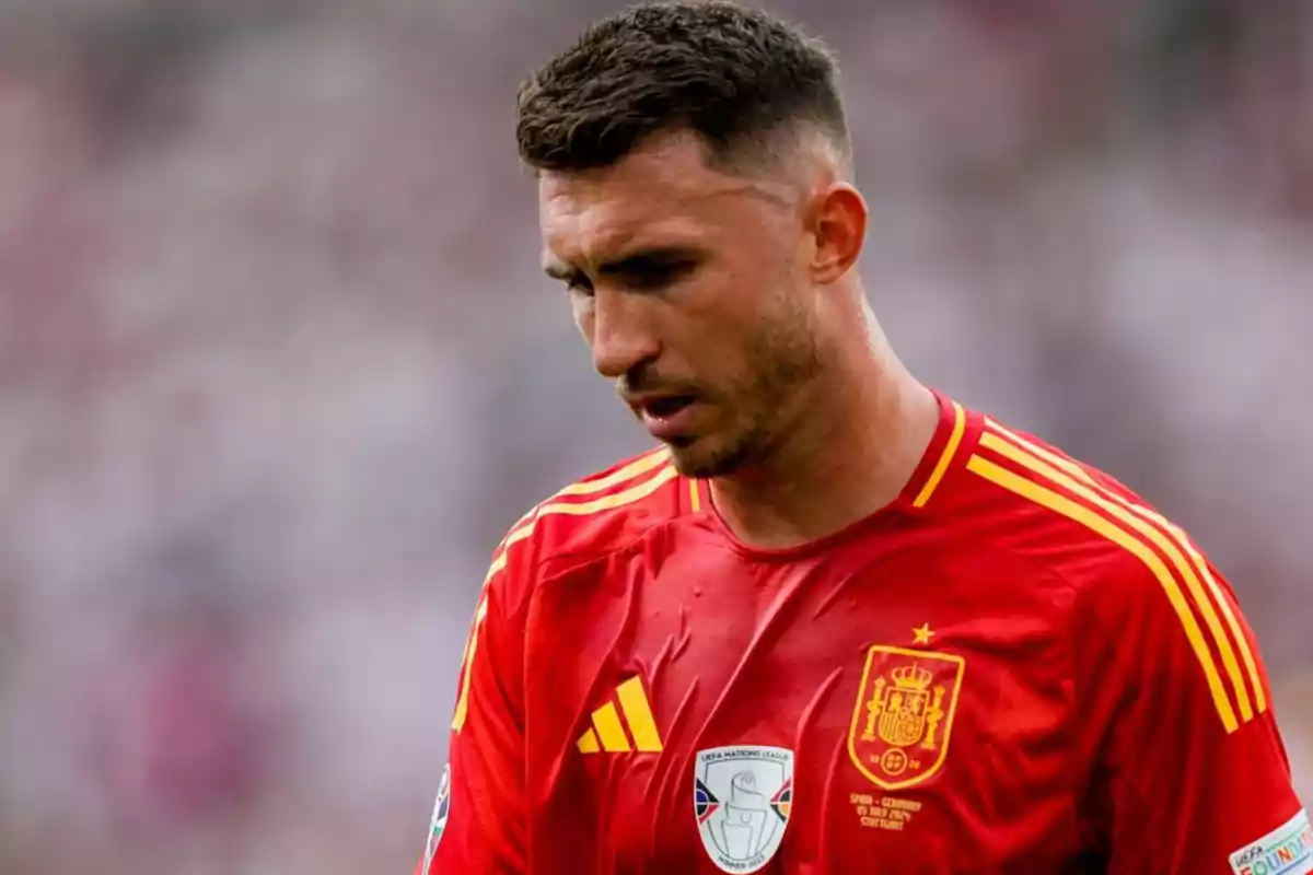 A soccer player wearing the red jersey of the Spanish national team during a match. A soccer player wearing the red jersey of the Spanish national team during a match.