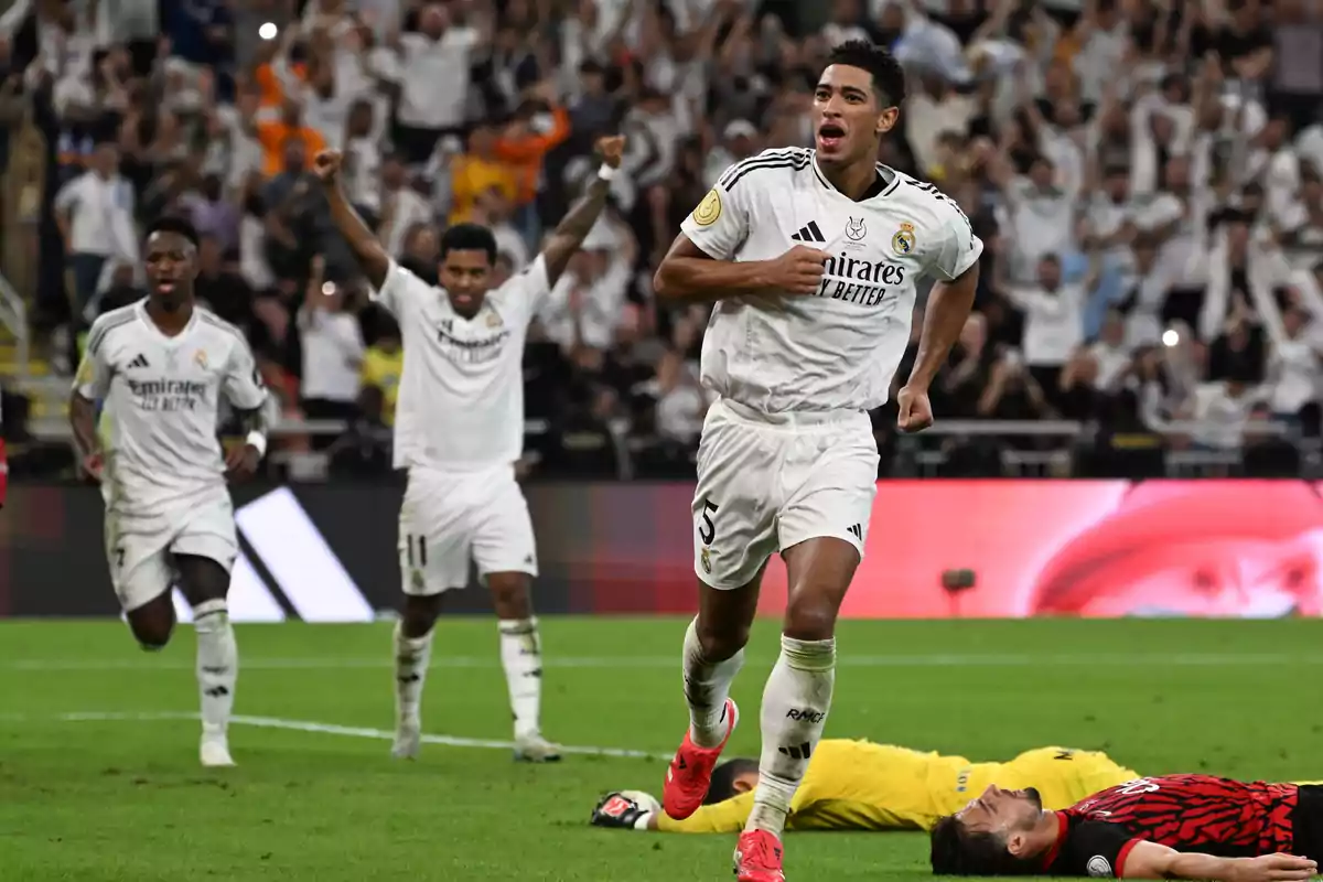 Football players celebrate a goal in a stadium full of fans. Football players celebrate a goal in a stadium full of fans.