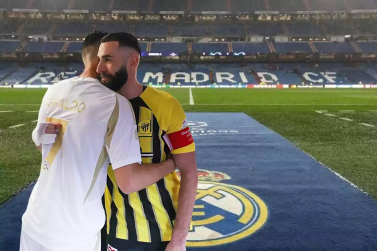 Two footballers hug each other on the field of the Real Madrid stadium.