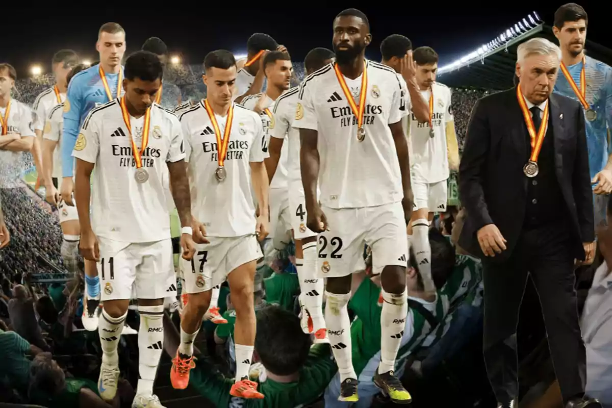 Soccer players with medals walking in a stadium full of spectators.