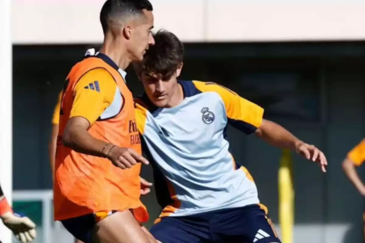 Two soccer players training on the field in Real Madrid training uniforms. Two soccer players training on the field in Real Madrid training uniforms.