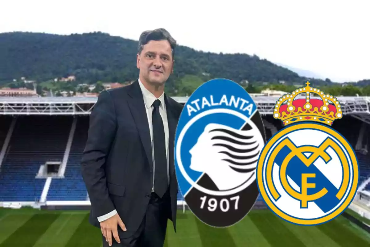 Man in suit in front of a stadium with the logos of Atalanta and Real Madrid.