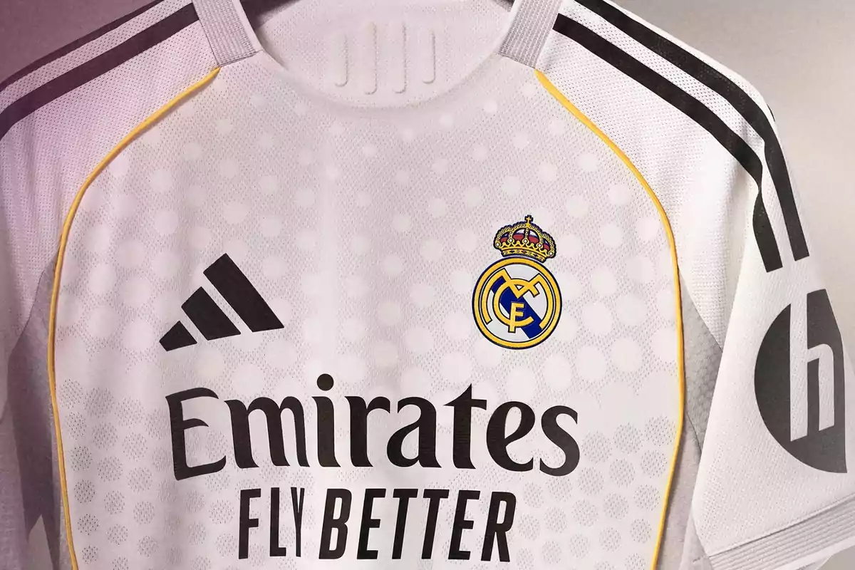 White Real Madrid jersey with yellow and black details, Adidas logo, club crest, and Emirates Fly Better sponsorship White Real Madrid jersey with yellow and black details, Adidas logo, club crest, and Emirates Fly Better sponsorship