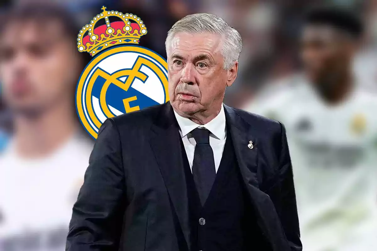 Un hombre de traje frente al logo del Real Madrid.