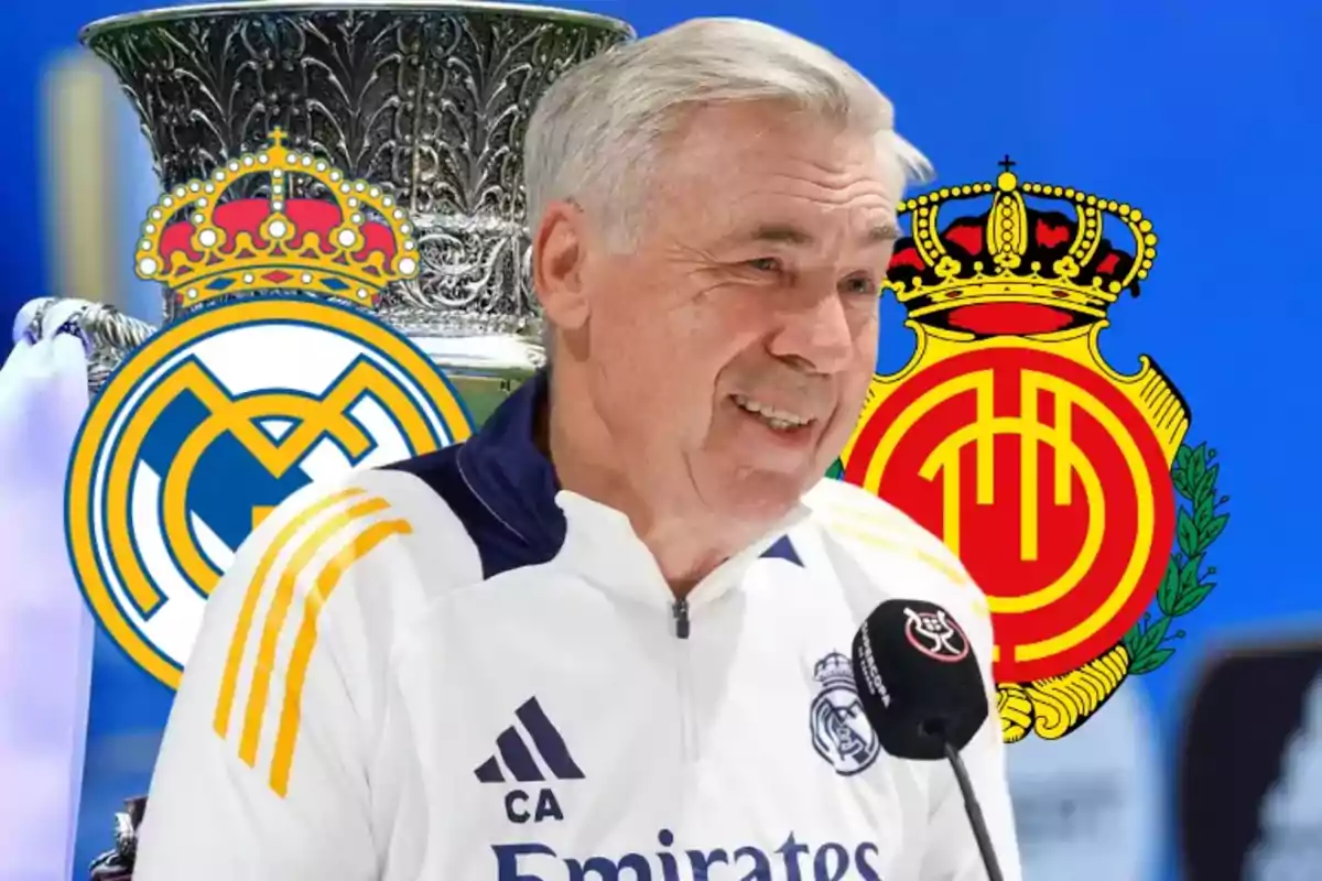 Un entrenador de fútbol sonríe durante una conferencia de prensa con los escudos del Real Madrid y el Mallorca de fondo.