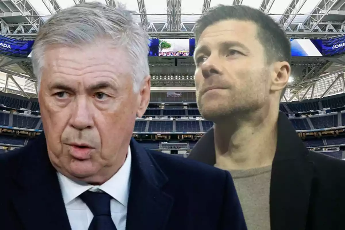 Two middle-aged men with serious expressions are inside a modern, empty soccer stadium.