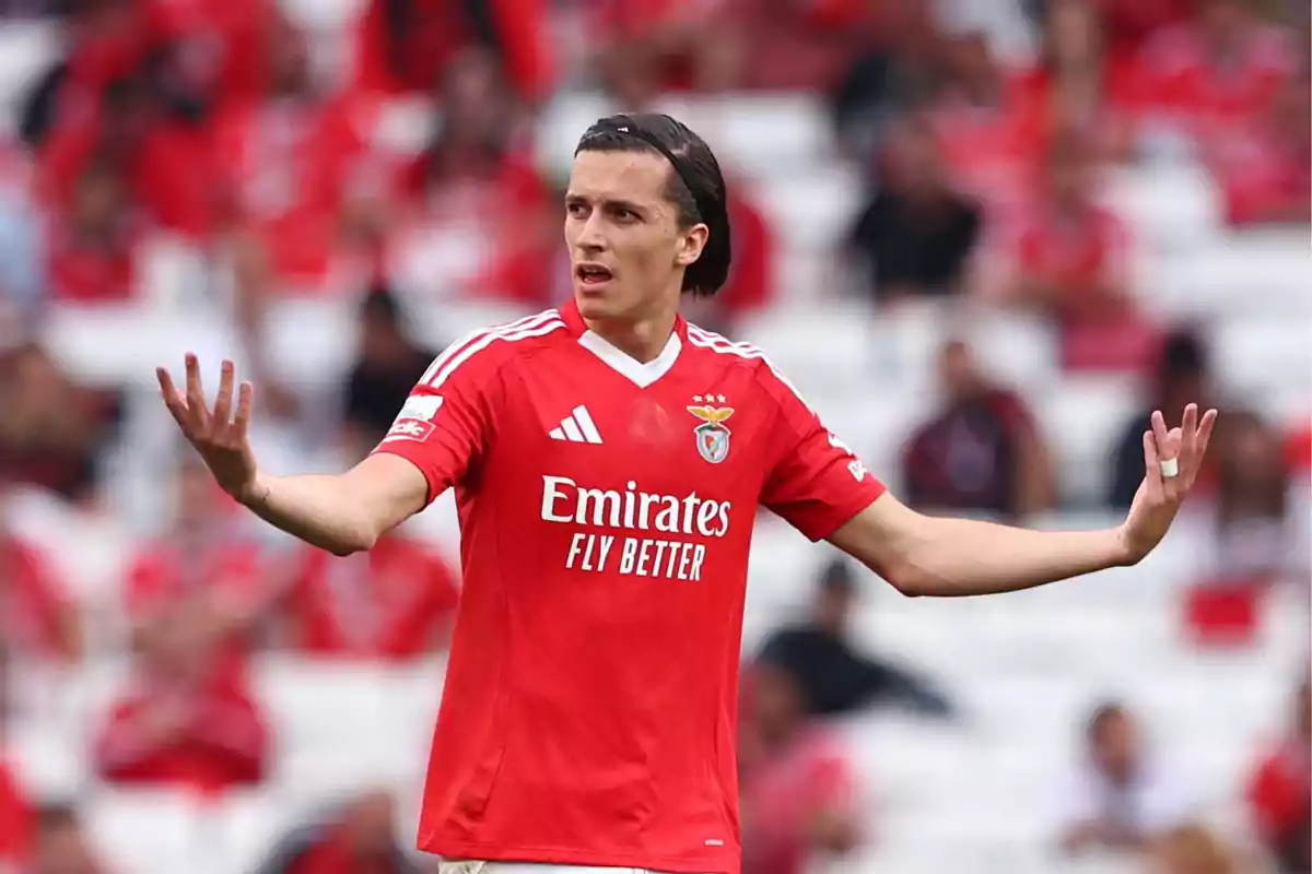 Benfica player with arms outstretched during a match at the stadium