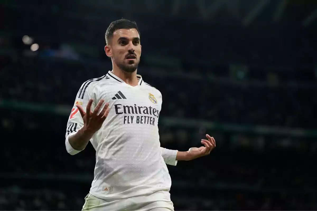 Real Madrid player in a white uniform gesturing during a match at the stadium Real Madrid player in a white uniform gesturing during a match at the stadium