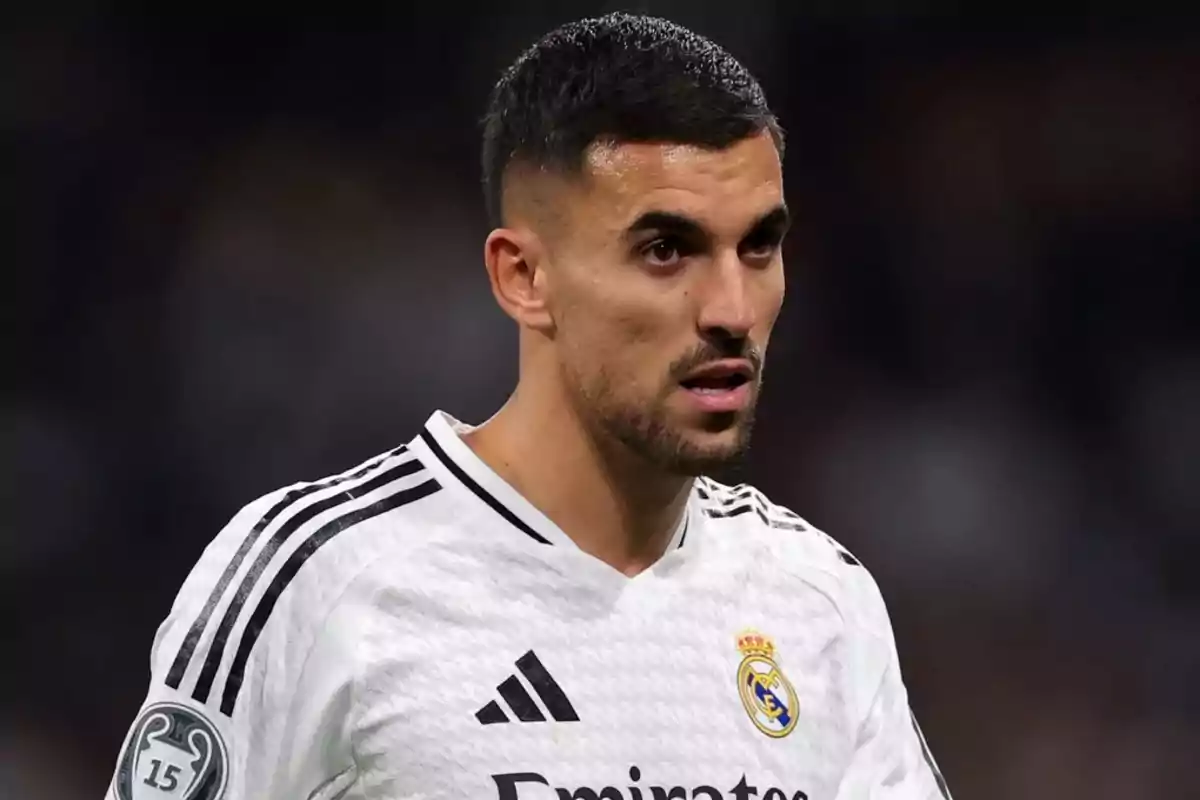 A player in a black and white Real Madrid uniform on the field.