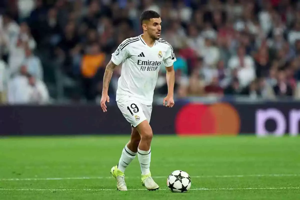Real Madrid player wearing number 19 controls the ball during a match in a stadium full of spectators Real Madrid player wearing number 19 controls the ball during a match in a stadium full of spectators