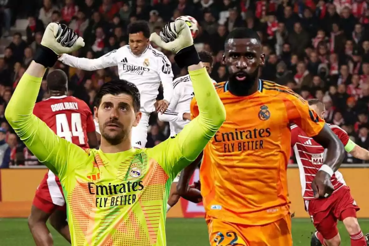 Jugadores de fútbol del Real Madrid en acción durante un partido, con un portero levantando los brazos y otro jugador en uniforme naranja.