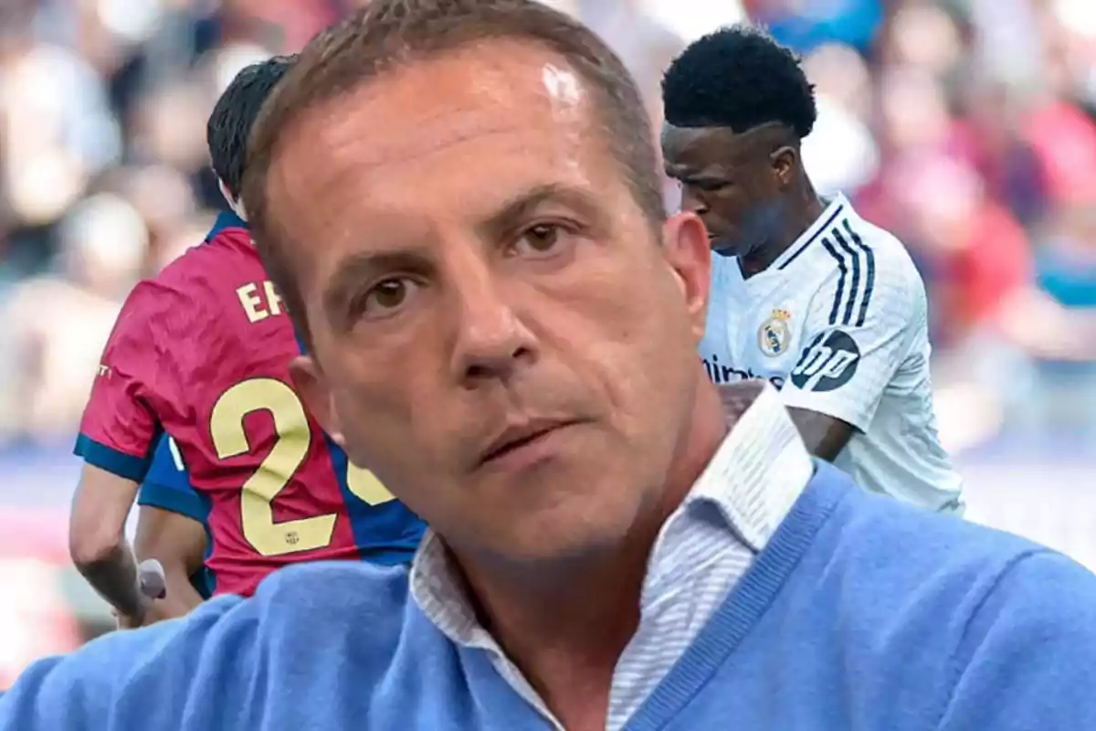 A man in the foreground with a serious expression, while in the background two players are in action, one wearing a white jersey and the other wearing a blue and red jersey.