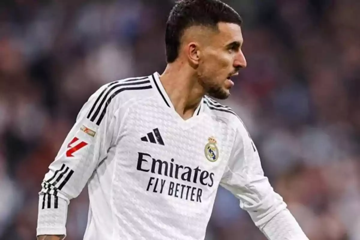Football player in white Real Madrid uniform on the playing field. Football player in white Real Madrid uniform on the playing field.