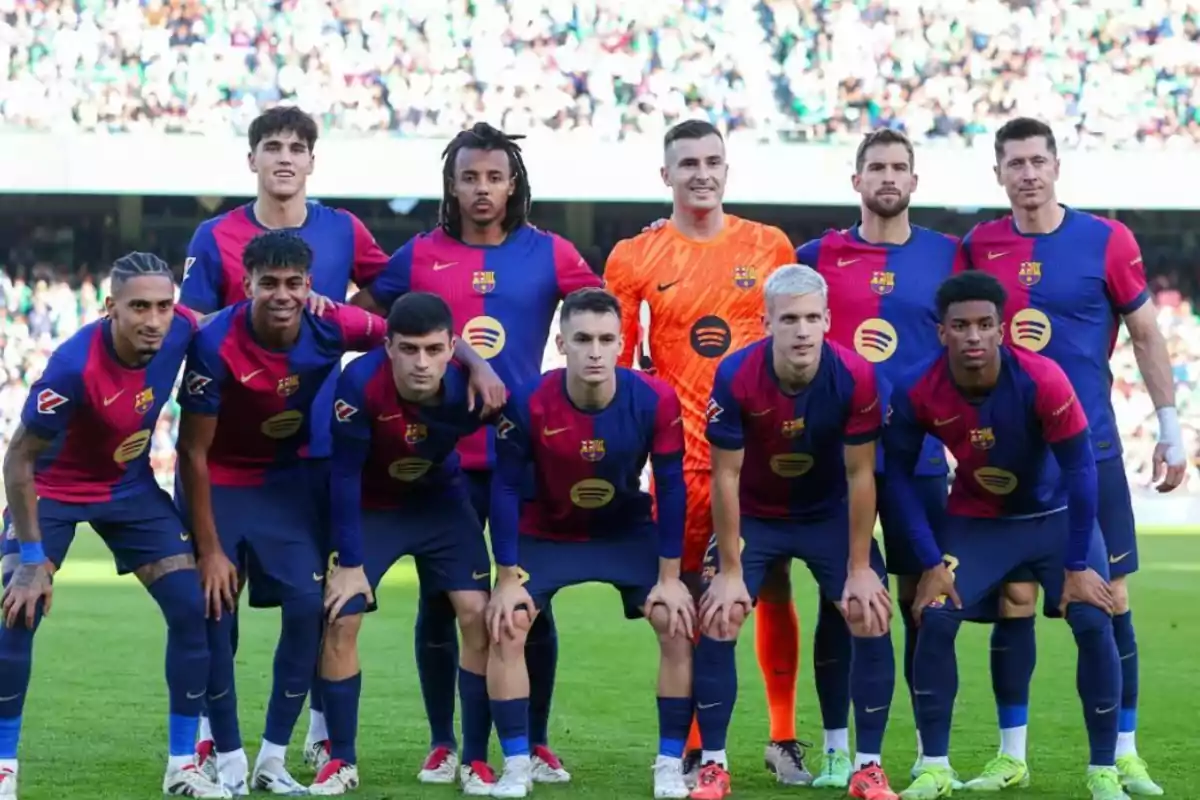 A soccer team posing for a group photo on the field before a match.