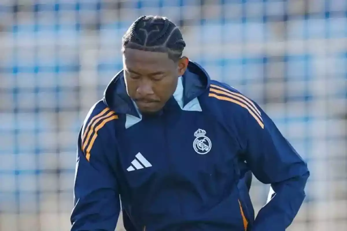 A soccer player wearing a Real Madrid jacket at a training camp. A soccer player wearing a Real Madrid jacket at a training camp.