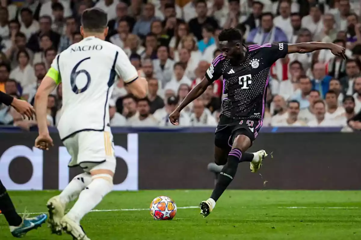 Two soccer players in action during a match, one in a white uniform and the other in a black uniform, in a stadium full of spectators. Two soccer players in action during a match, one in a white uniform and the other in a black uniform, in a stadium full of spectators.