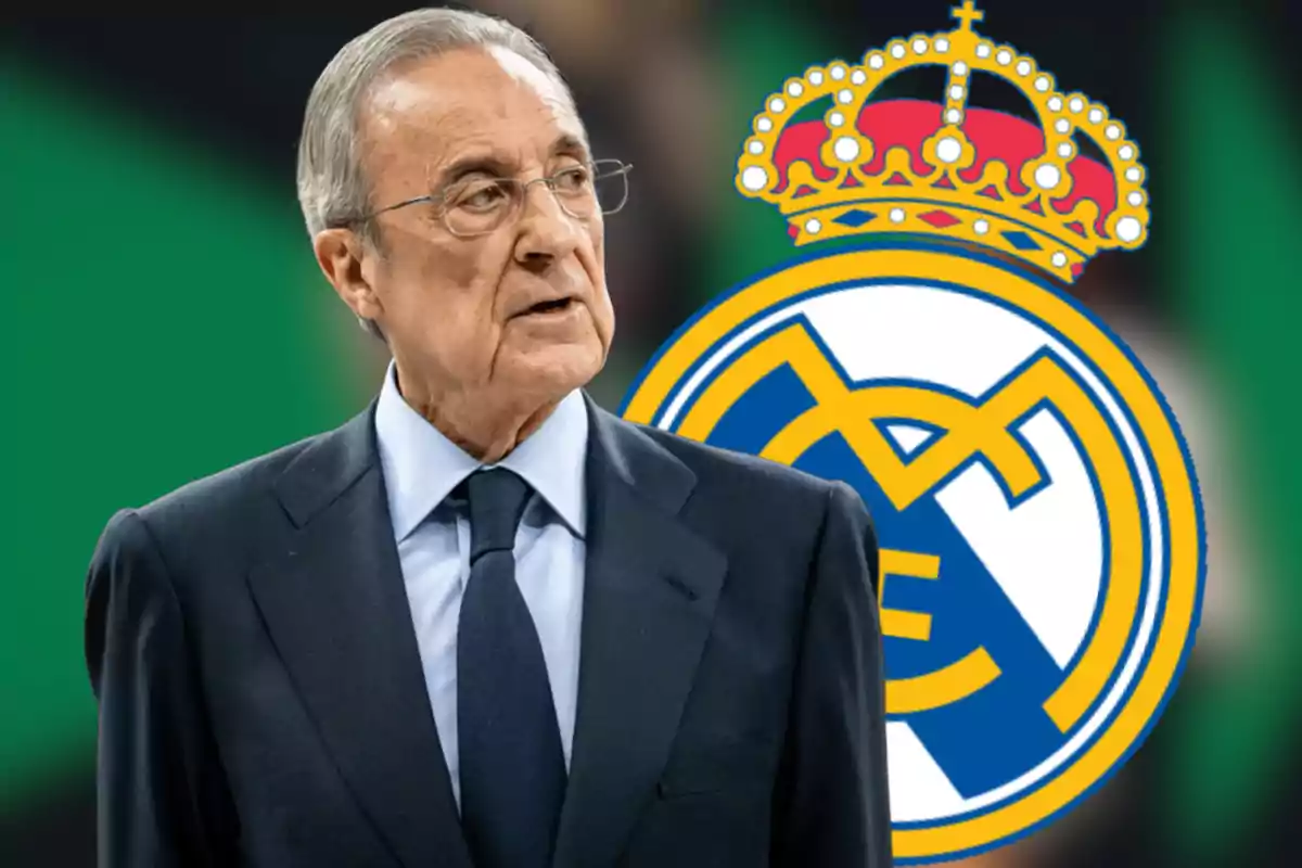 Hombre de cabello canoso con gafas y traje oscuro frente al escudo del Real Madrid