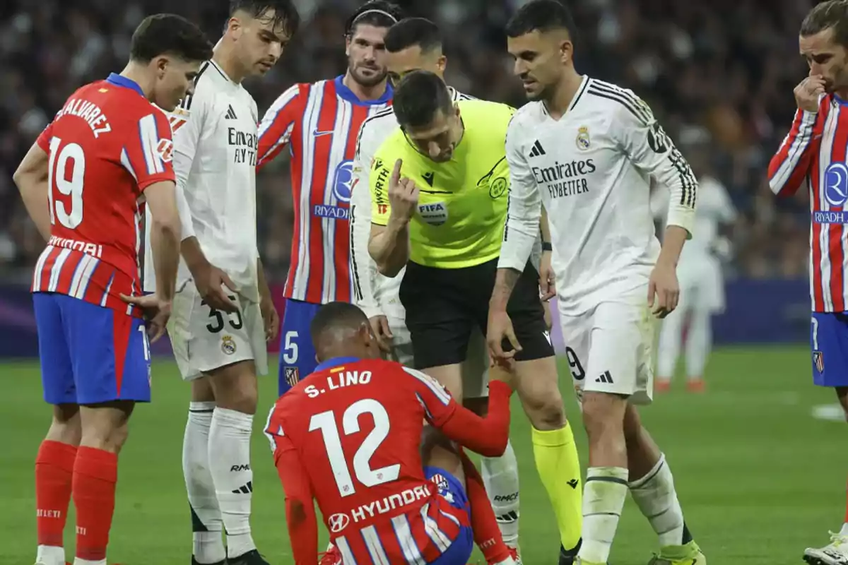 Soccer players from two different teams interact with the referee during a match.