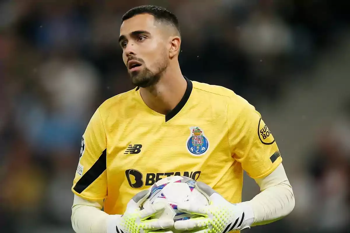 Porto’s goalkeeper in a yellow uniform holding a ball during a soccer match Porto’s goalkeeper in a yellow uniform holding a ball during a soccer match