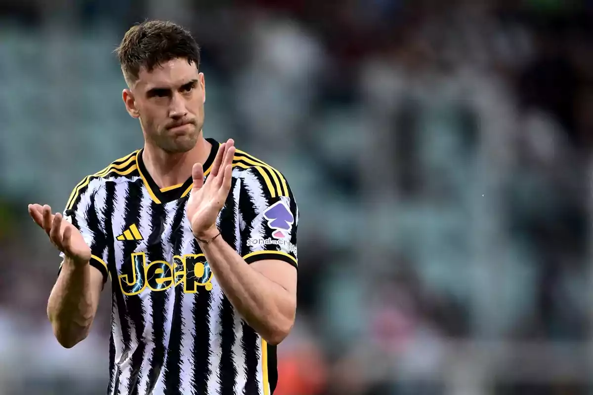 Soccer player in a Juventus uniform applauding on the field Soccer player in a Juventus uniform applauding on the field