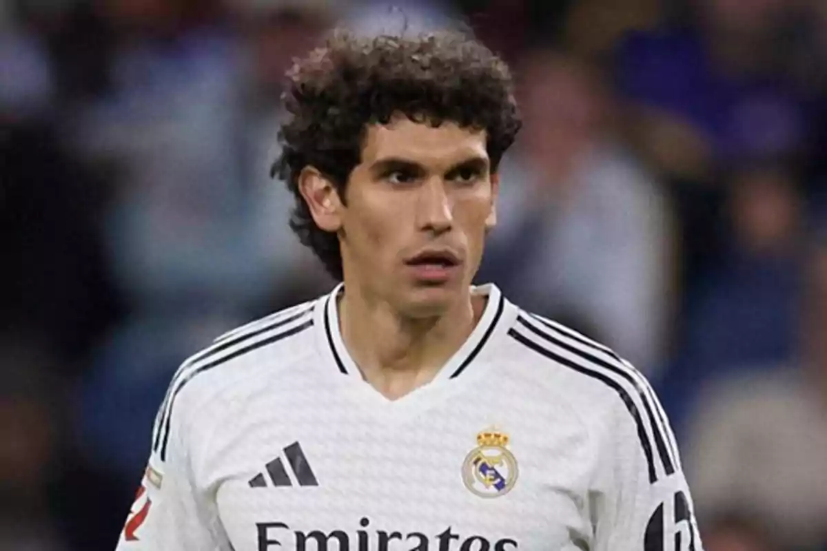 Football player wearing a Real Madrid jersey on the field.