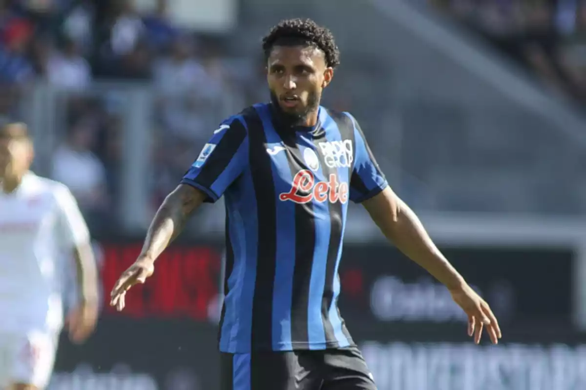 Soccer player in blue and black uniform on the field during a match.