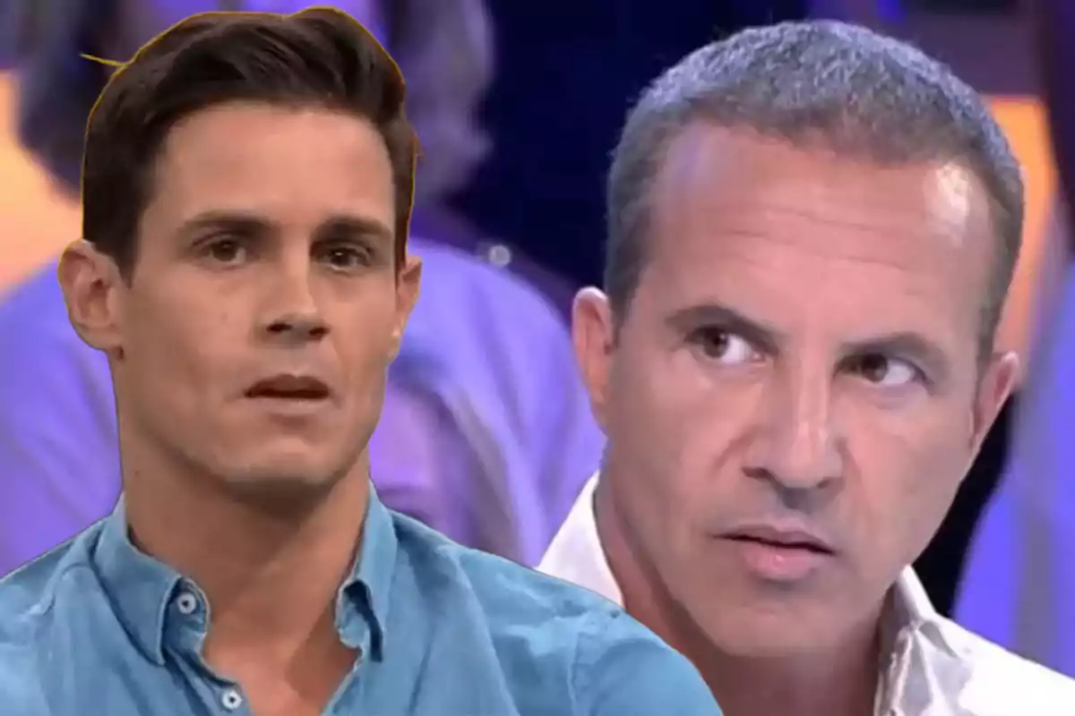 Two men on a TV show with serious expressions and an out-of-focus background.