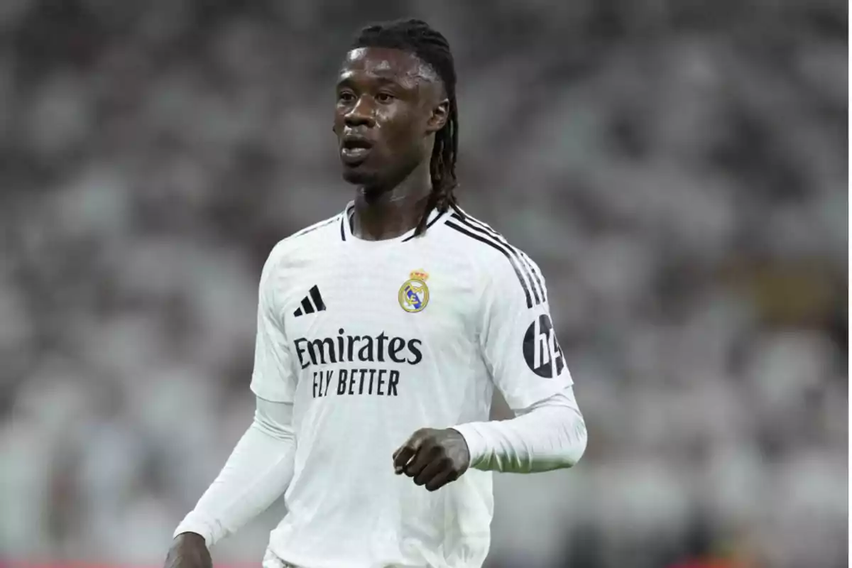 Real Madrid player in a white uniform during a match Real Madrid player in a white uniform during a match