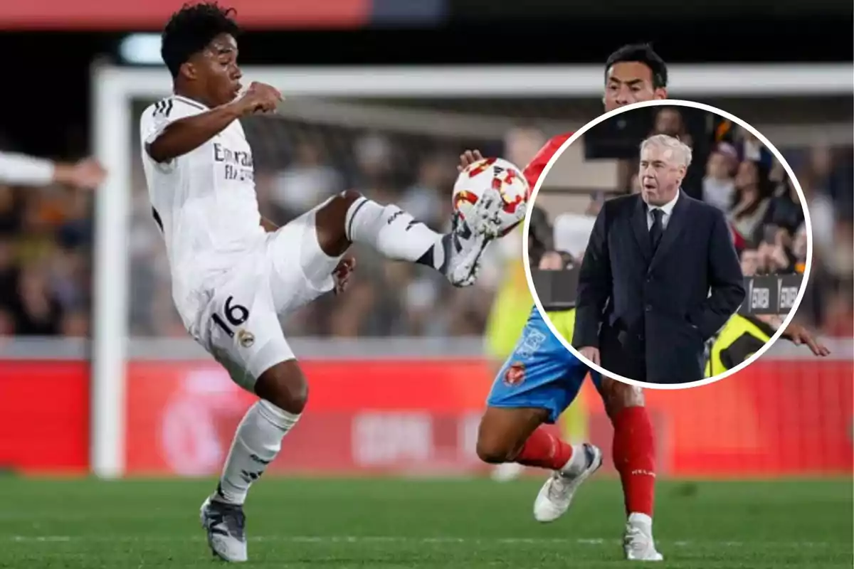 Un jugador de fútbol del Real Madrid controla el balón en el aire durante un partido, mientras un entrenador observa desde la línea de banda.