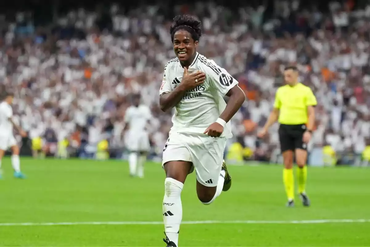 A soccer player running on the field with a crowd of spectators in the background. A soccer player running on the field with a crowd of spectators in the background.