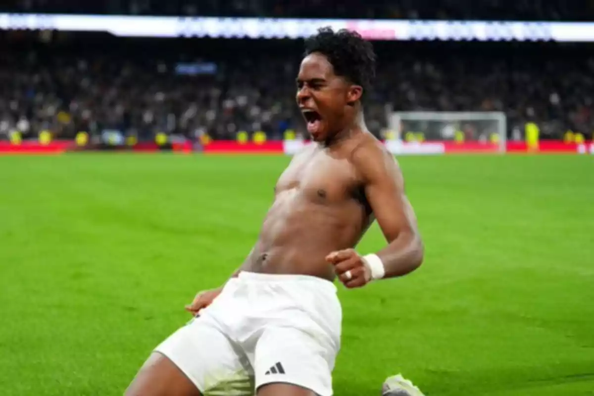 A soccer player celebrates enthusiastically on the field after scoring a goal. A soccer player celebrates enthusiastically on the field after scoring a goal.