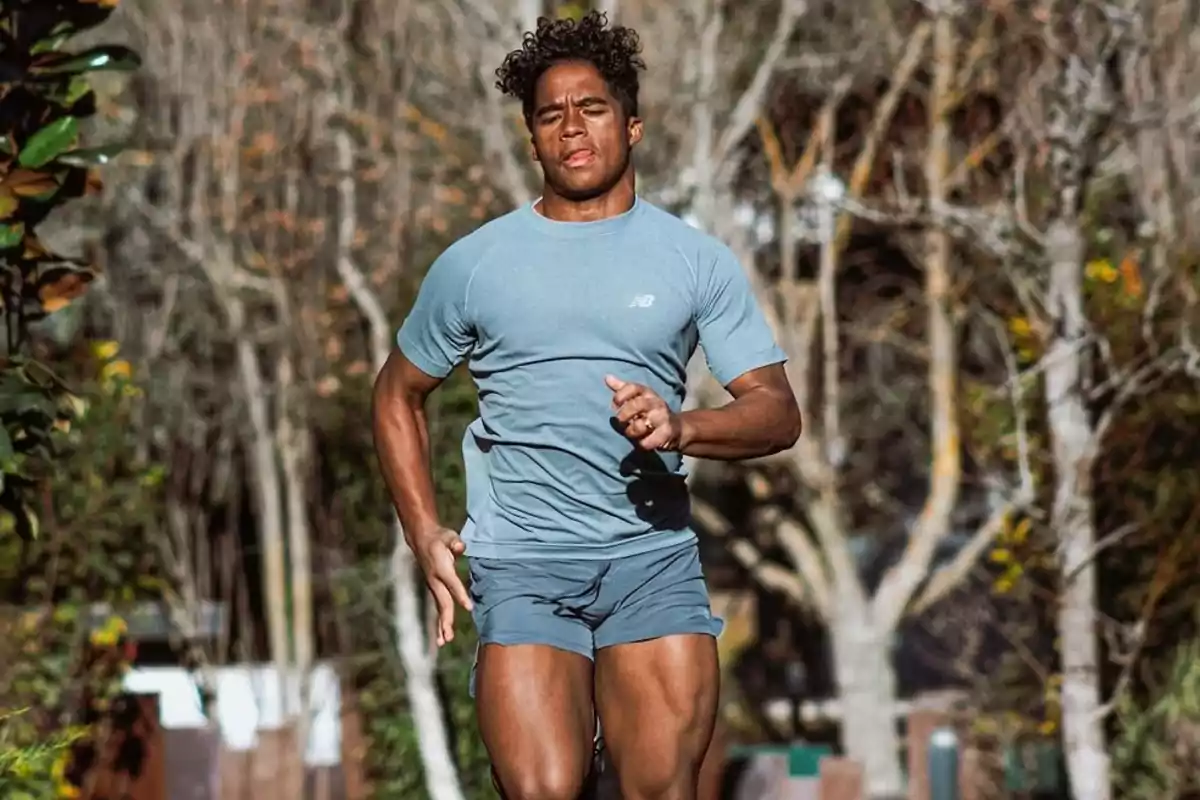 Man running outdoors in natural setting with trees in background. Man running outdoors in natural setting with trees in background.