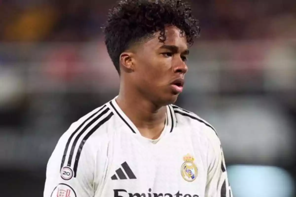 Football player in a white Real Madrid jersey on the field. Football player in a white Real Madrid jersey on the field.