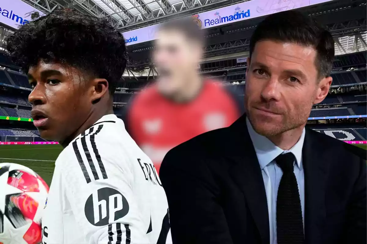 A young player in a white uniform and a man in a suit pose in a soccer stadium with the Real Madrid logo in the background and a blurred figure in the center.