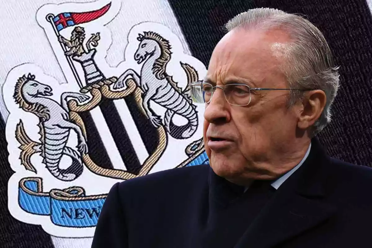 An older man with glasses and gray hair is in front of a soccer team crest that features seahorses and a red flag.