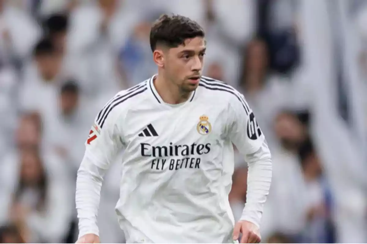 Real Madrid player in a white uniform during a match Real Madrid player in a white uniform during a match