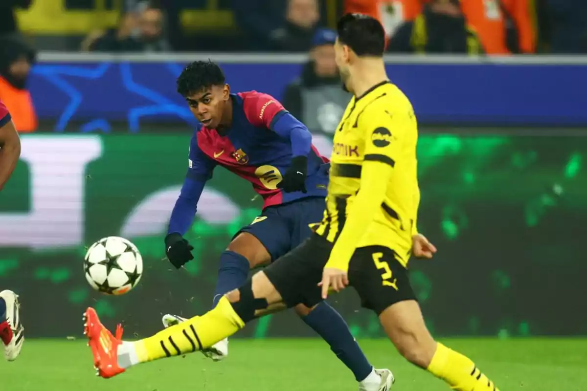 A Barcelona player tries to control the ball as a Borussia Dortmund player approaches to contest the play in a soccer match.