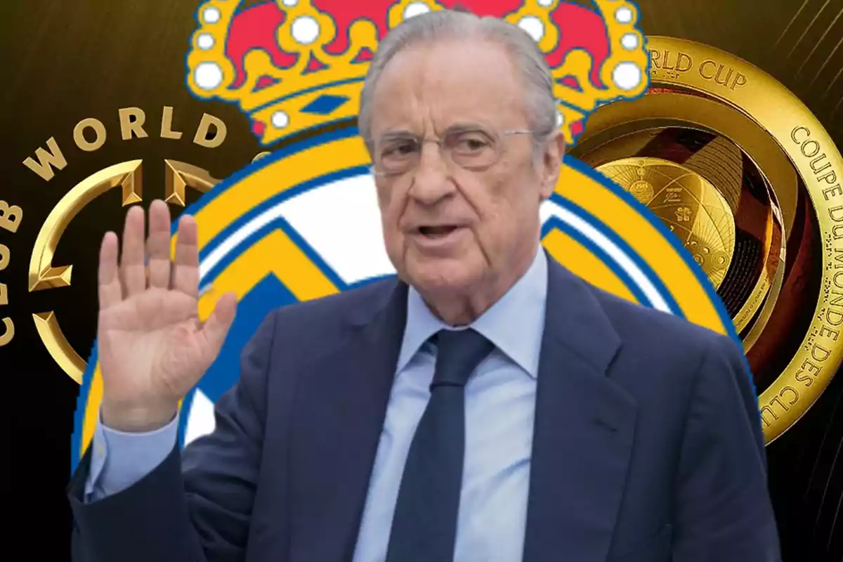 An older man with glasses and a dark suit raises his hand in front of a background with a soccer team's emblem and trophies.