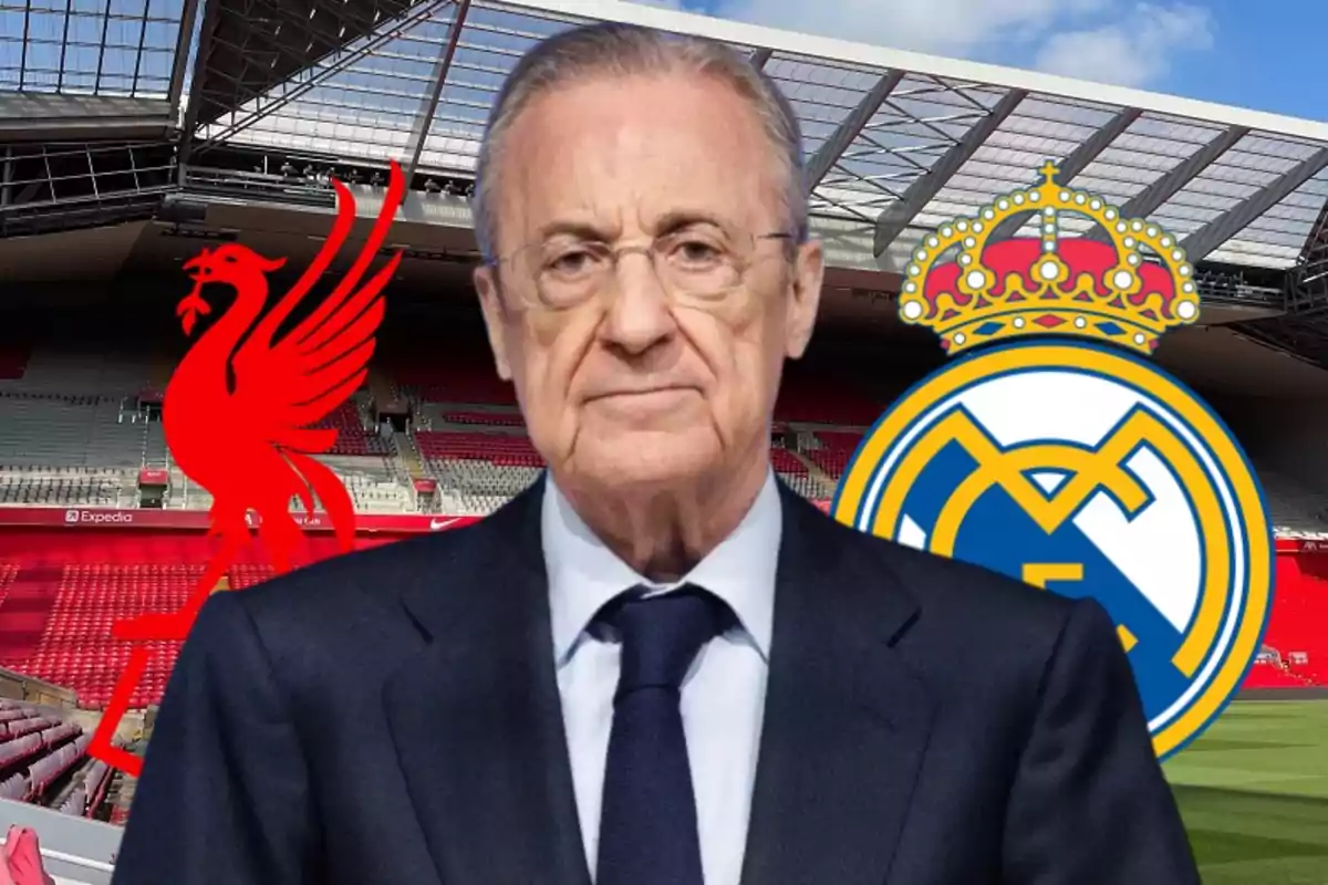 A man in a suit in front of the Liverpool and Real Madrid logos in a stadium.