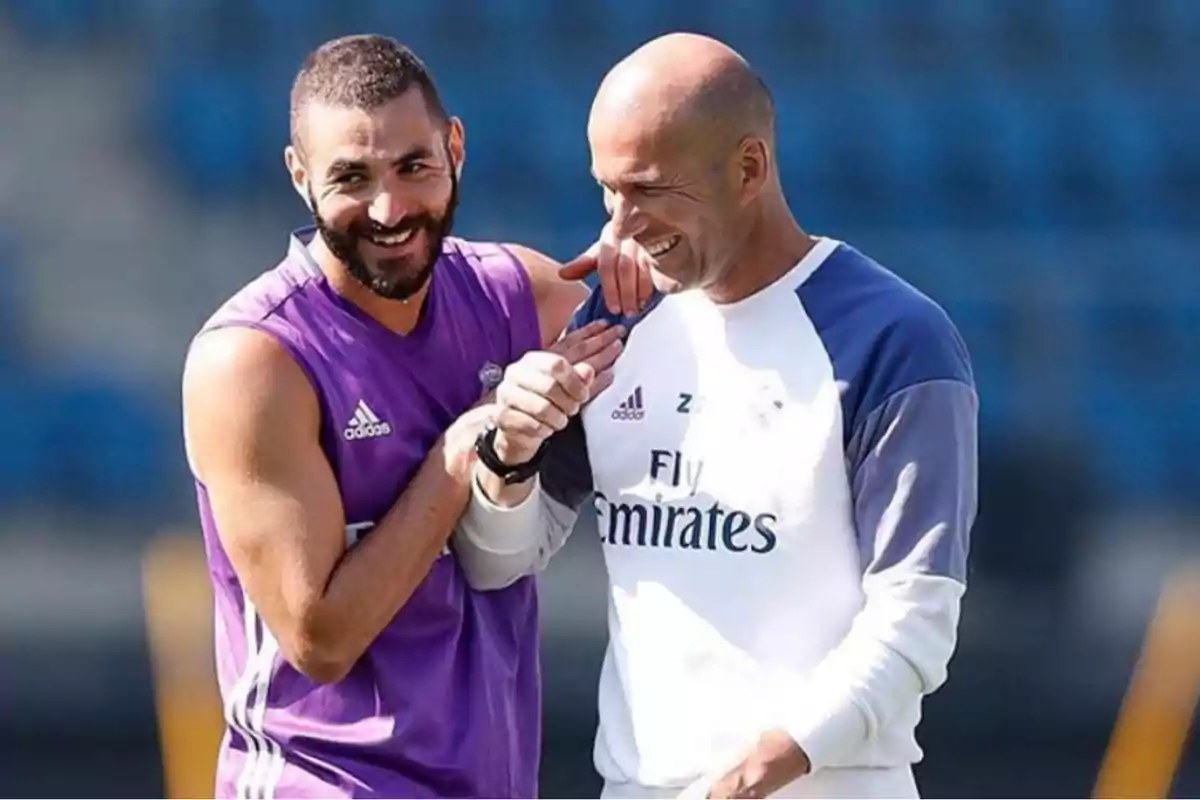 Two men smile and hug each other at a training camp. Two men smile and hug each other at a training camp.