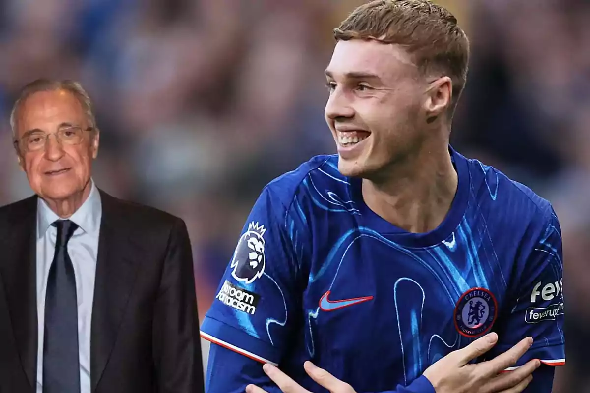 An older man in a suit stands next to a smiling soccer player in a Chelsea uniform.