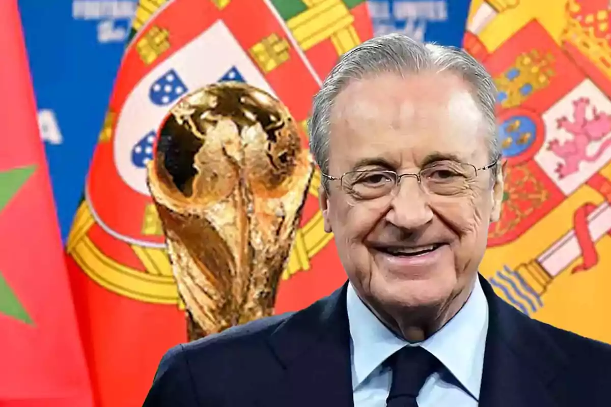 Un hombre sonriente con gafas y traje frente a un trofeo dorado y banderas de Marruecos, Portugal y España.