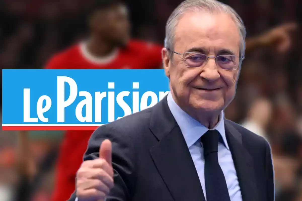 A man in a suit and tie smiles and gives a thumbs-up gesture in front of a background displaying the "Le Parisien" logo.