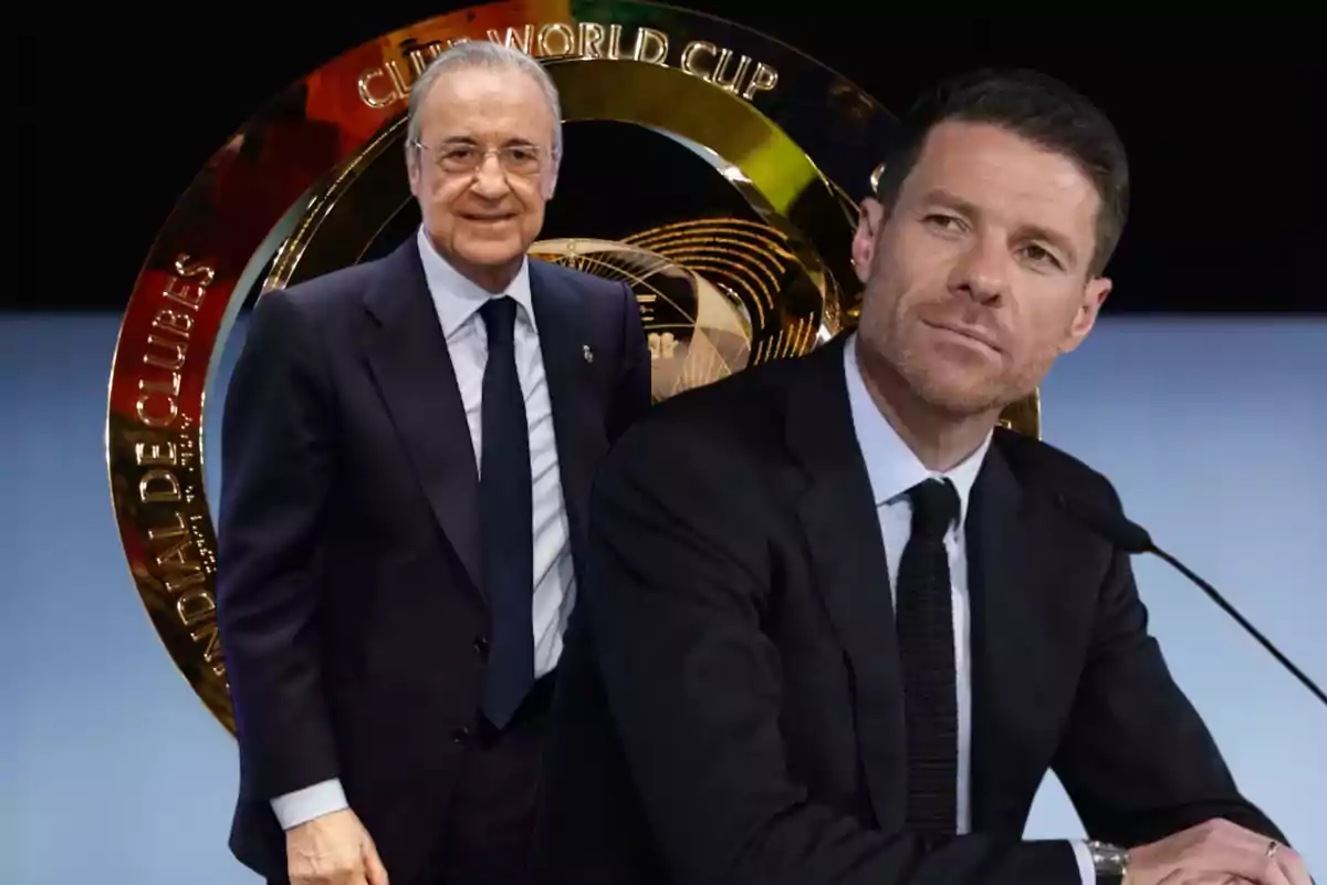 Two men in suits pose in front of a dark background with a large golden FIFA Club World Cup trophy.